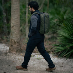 Man rucking in outdoor trail with GORUCK backpack, wearing brown GORUCK MACV-2 Mid boots.