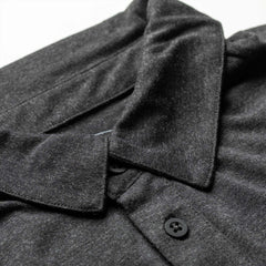 GORUCK men's black triblend polo shirt with pocket and black buttons, close-up view