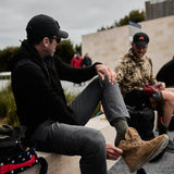 Man outdoors wearing GORUCK Ranger Green Merino Wool Socks and tan rucking boots