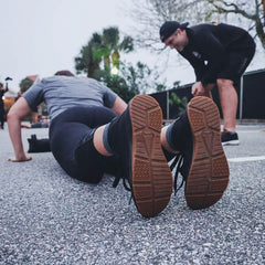 GORUCK rucking boots during outdoor fitness training, person doing push-ups on pavement