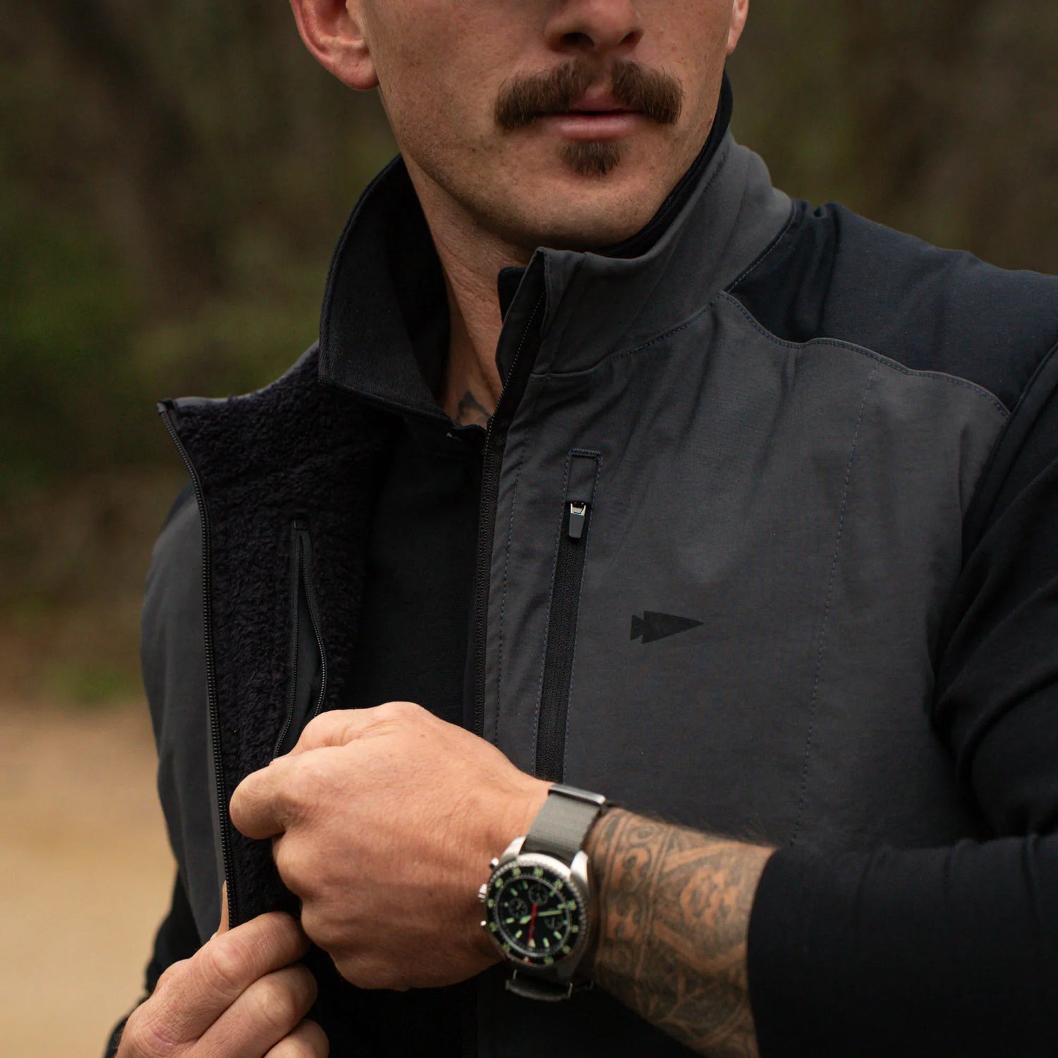 Man wearing GORUCK tactical jacket outdoors, showing rugged rucking gear style