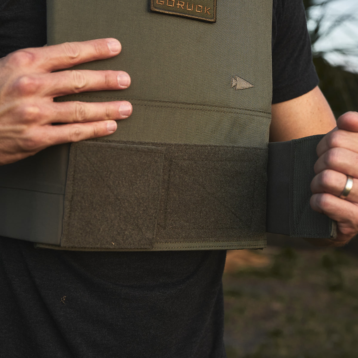 Someone wearing the Training Weight Vest 2.0 in green.