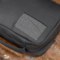 GORUCK padded field pocket in Armor Grey durable fabric on wooden surface