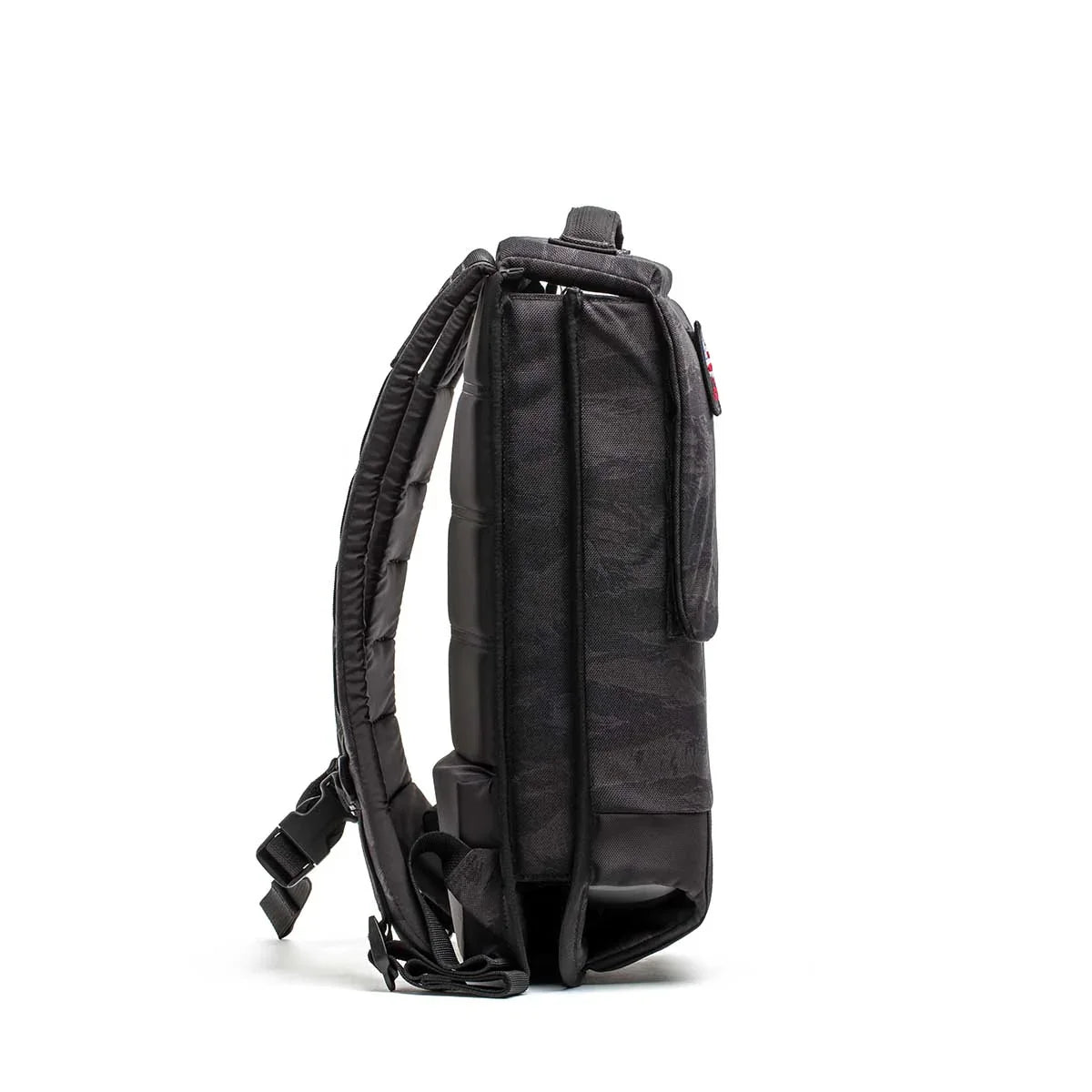 Side view of GORUCK black tactical rucksack with padded straps on white background