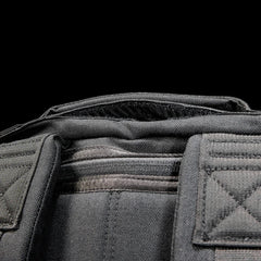 Close-up of GORUCK Radio Ruck black backpack top handle and rugged stitching detail