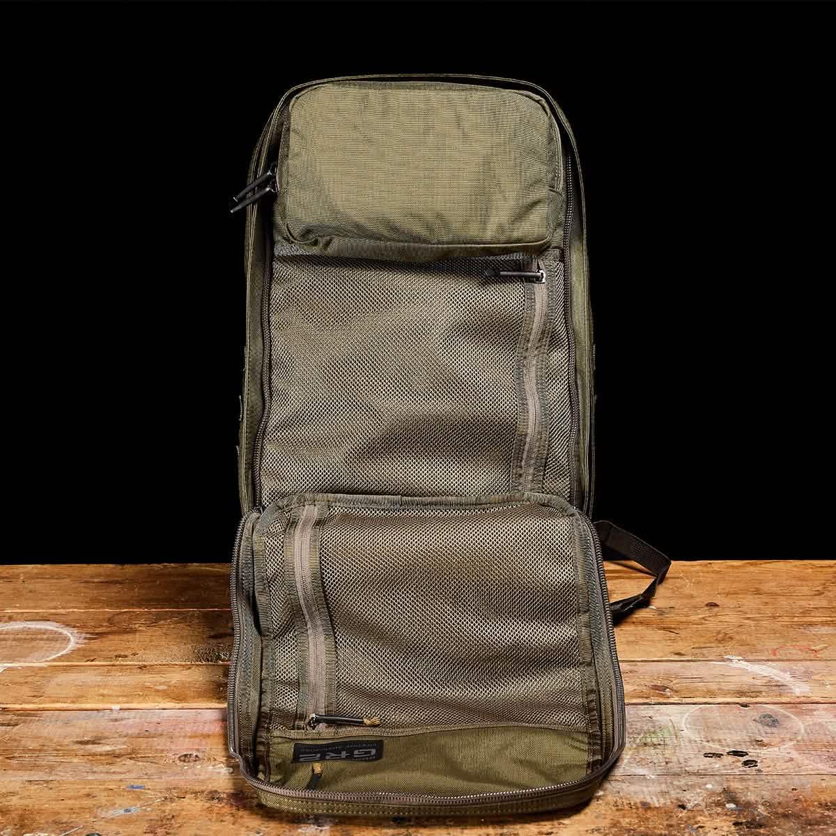 GORUCK ranger green rucking backpack fully open on wooden table, showing mesh pockets