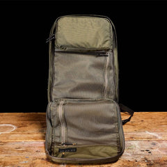 GORUCK ranger green rucking backpack fully open on wooden table, showing mesh pockets