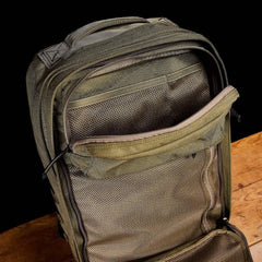 GORUCK Ranger Green tactical backpack open to show mesh interior pockets on wood surface