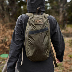 GORUCK Ranger Green packable backpack worn outdoors in rain, durable rucking gear