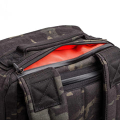 GORUCK black Multicam rucking gear bag with open zipper showing orange interior