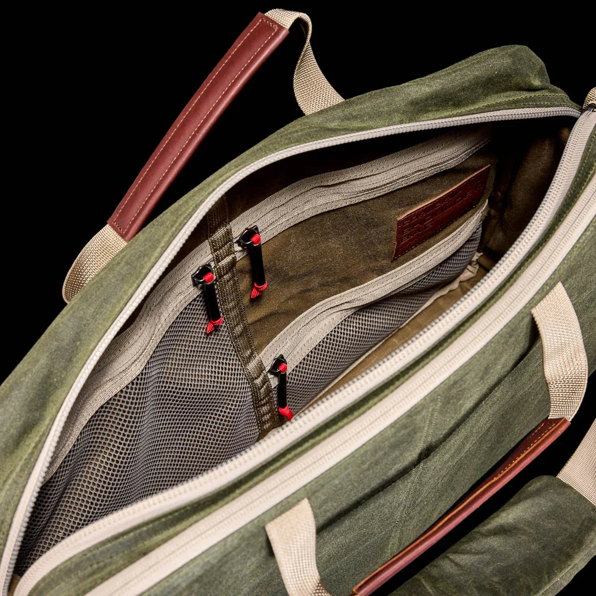 GORUCK olive waxed canvas shoulder bag 15L, tan handles, open with mesh pockets visible