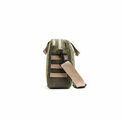 GORUCK olive green waxed canvas shoulder bag with field tan strap, side view on white background