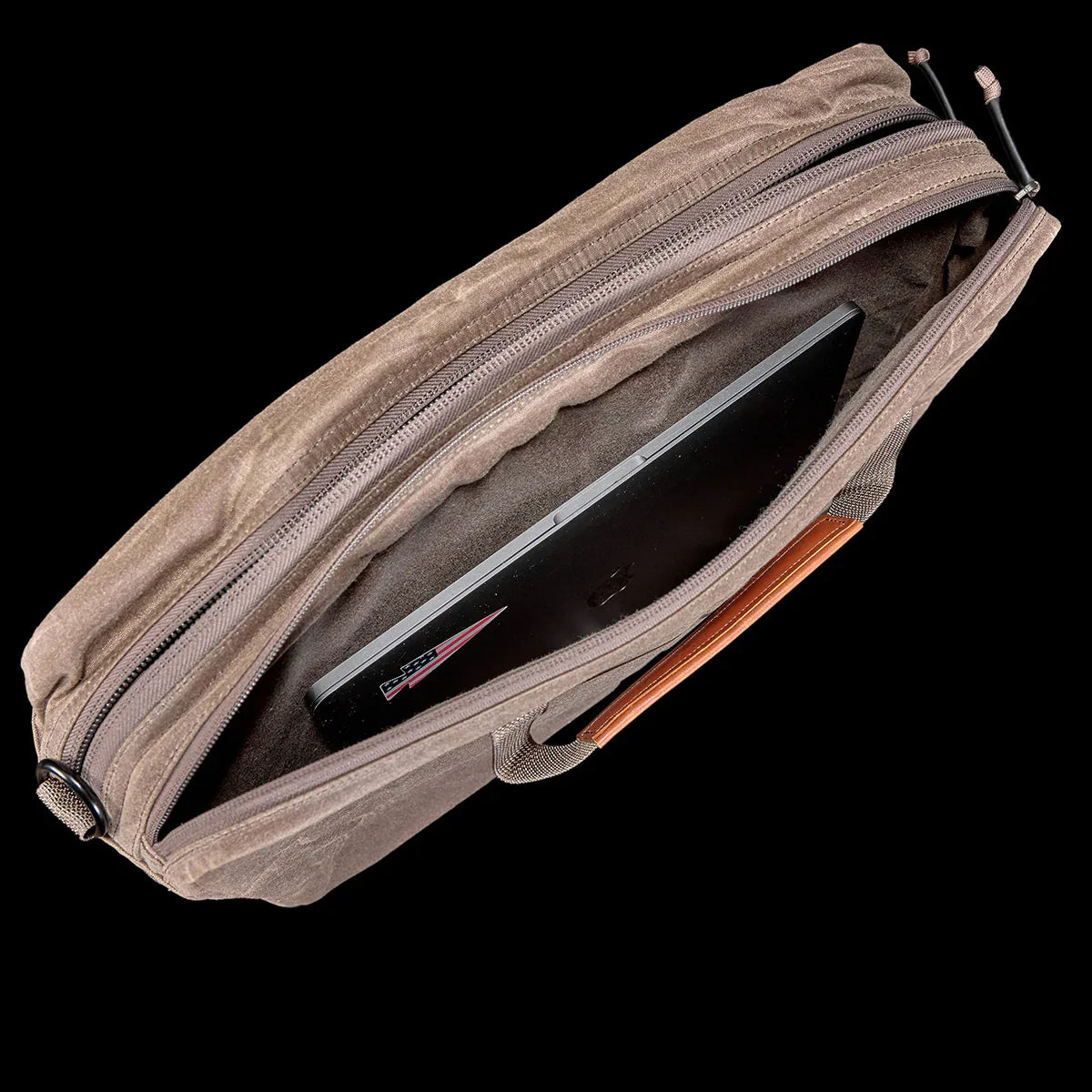 GORUCK shoulder bag in dark oak waxed canvas, open to show laptop inside main compartment