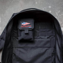 GORUCK rucksack open to show inside side pocket and patch with American flag logo
