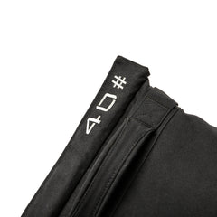 Close-up of a Simple Training Sandbags black fabric sandbag with white "04" text on its folded edge, perfect for sandbag training or as versatile equipment for your home gym.