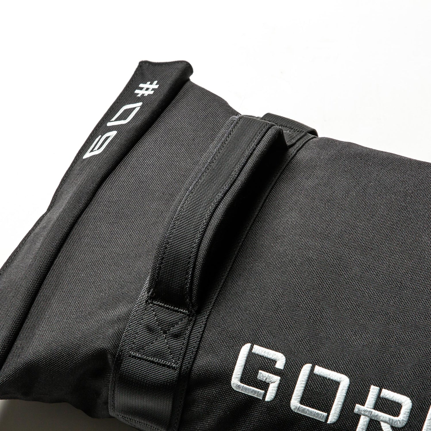 The Simple Training Sandbags feature a black design with a handle and white stitched 