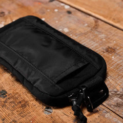 GORUCK black sternum pouch on rustic wooden surface, rugged rucking gear accessory