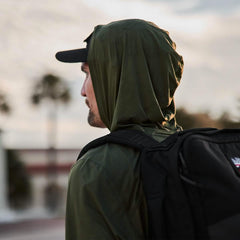 Man in green GORUCK Tough Mesh Hoodie with black backpack outdoors, rucking gear focus