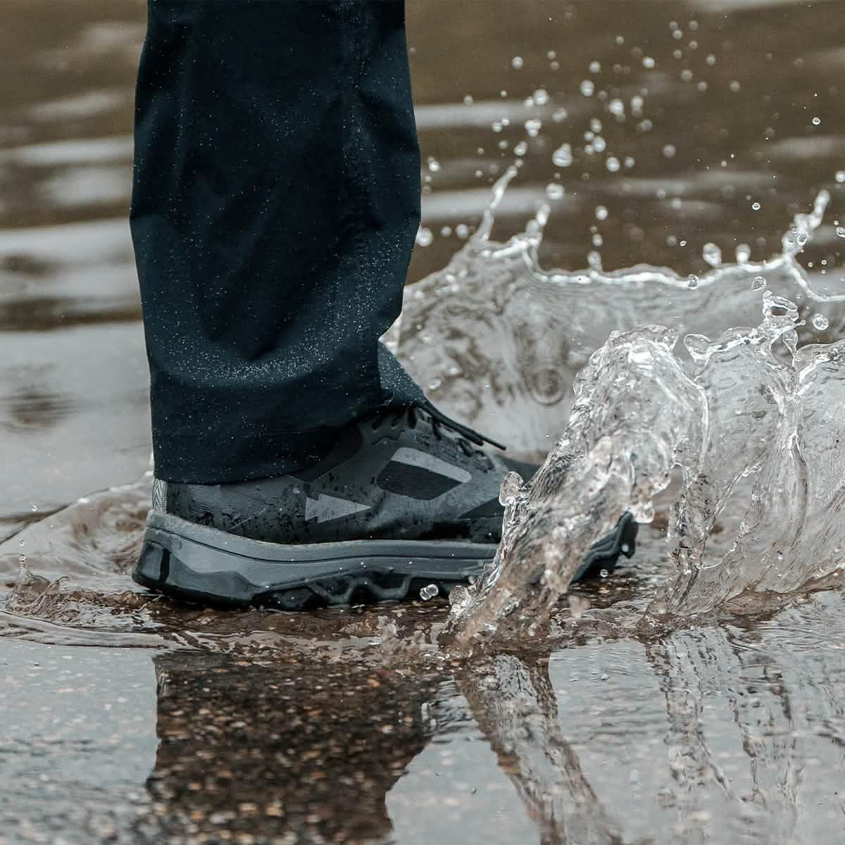 GORUCK Trail Merino Sock Charcoal in black shoe splashing through water outdoors