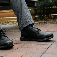 GORUCK black leather rucking boots on brick walkway, durable footwear for outdoor adventures
