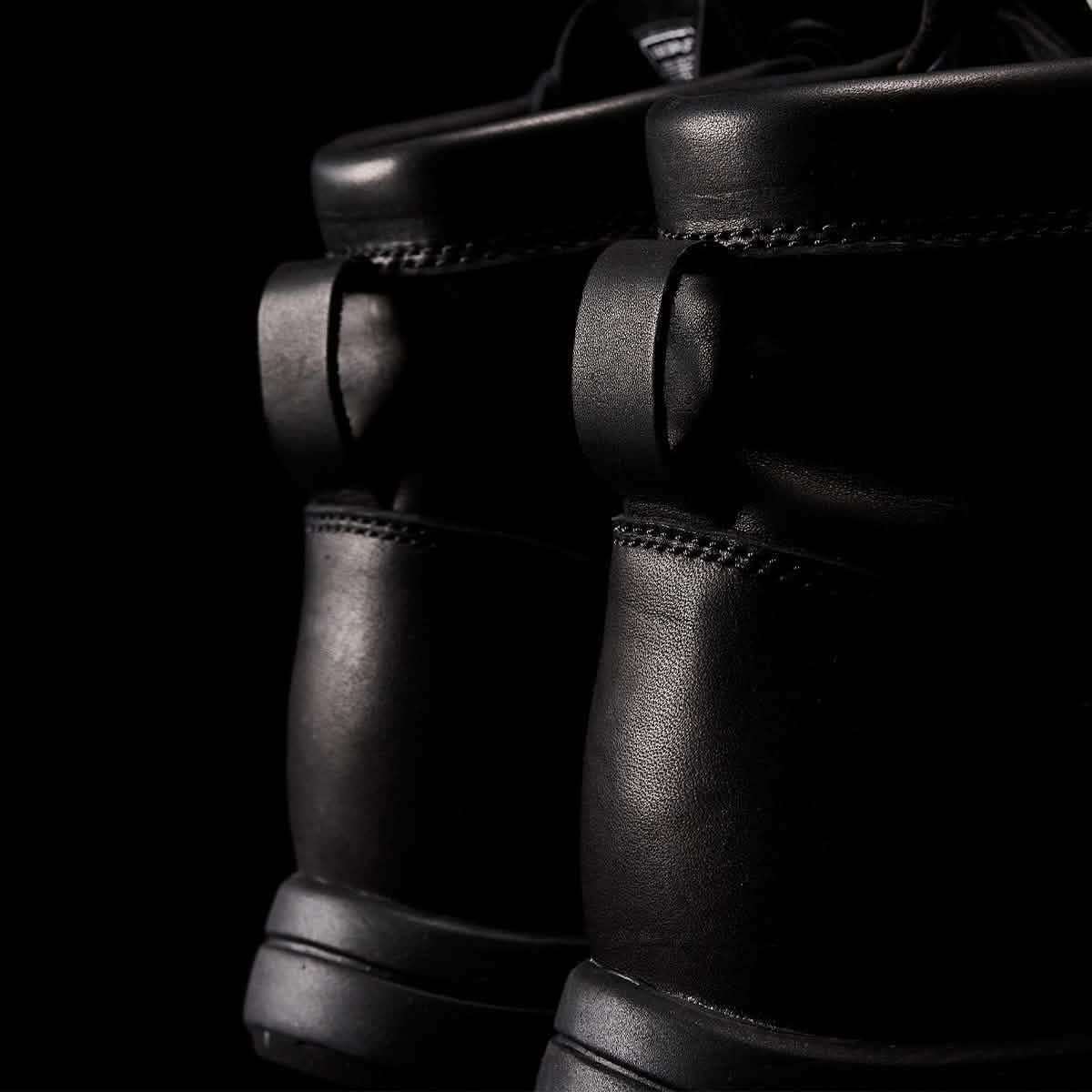 Close-up of black GORUCK rucking boots with rugged leather design and reinforced stitching.