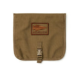 The brown Wire Dopp features a buckle closure and a rectangular patch with a spear and flag design, making it ideal for carrying your EDC essentials or using as a compact travel organizer.