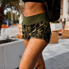 GORUCK women's training shorts in frogskin camo pattern outdoors