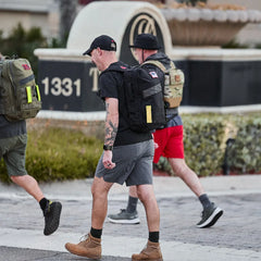 Group of people rucking in GORUCK backpacks and athletic apparel outdoors