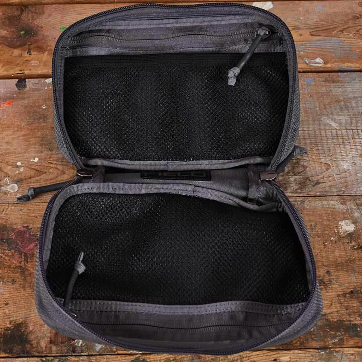 GORUCK black mesh utility pouch open on rustic wooden surface, durable rucking gear