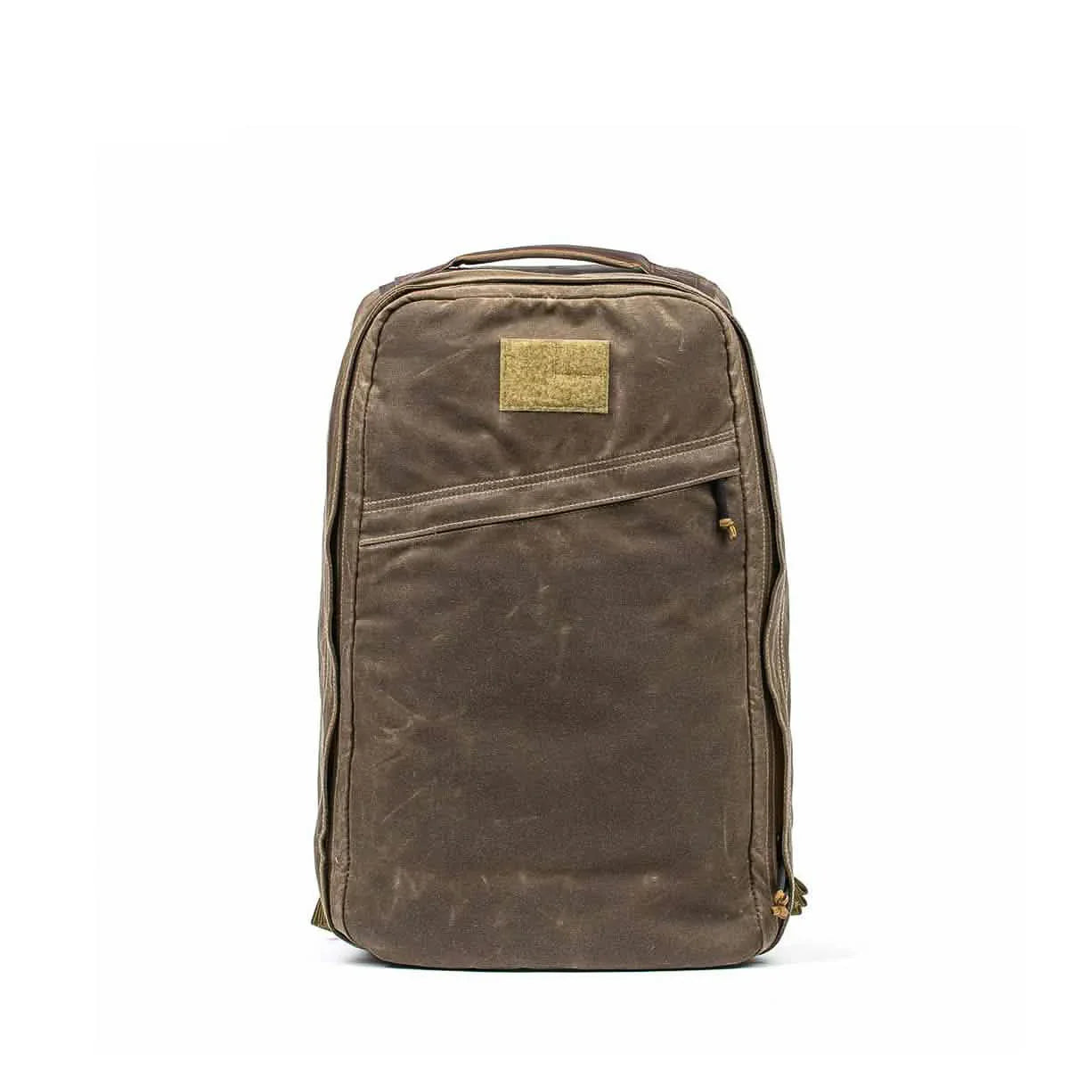 GORUCK dark oak rugged backpack with front zipper pocket and top handle against white background