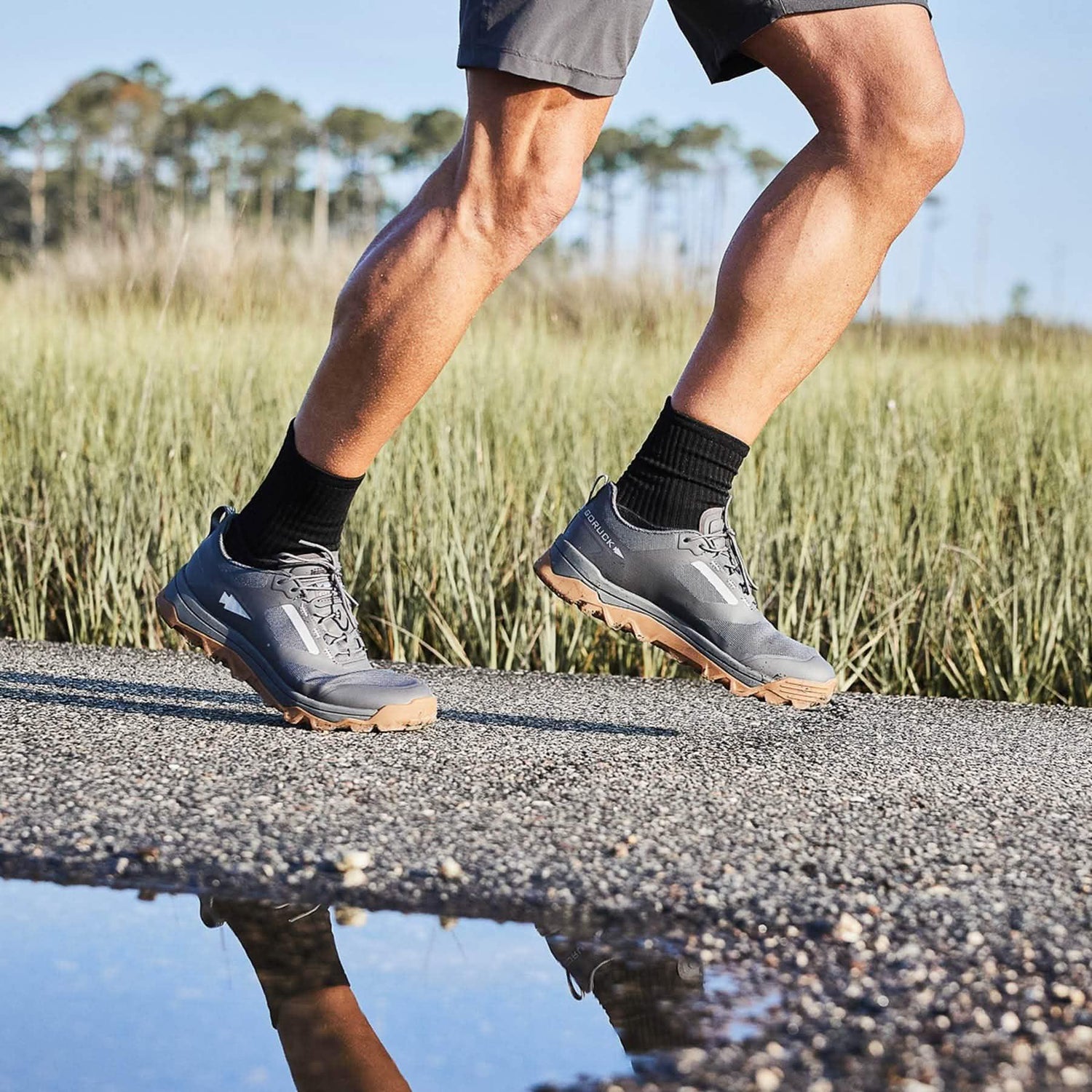 GORUCK rucking shoes on person running outdoors, gravel path with grassy field background