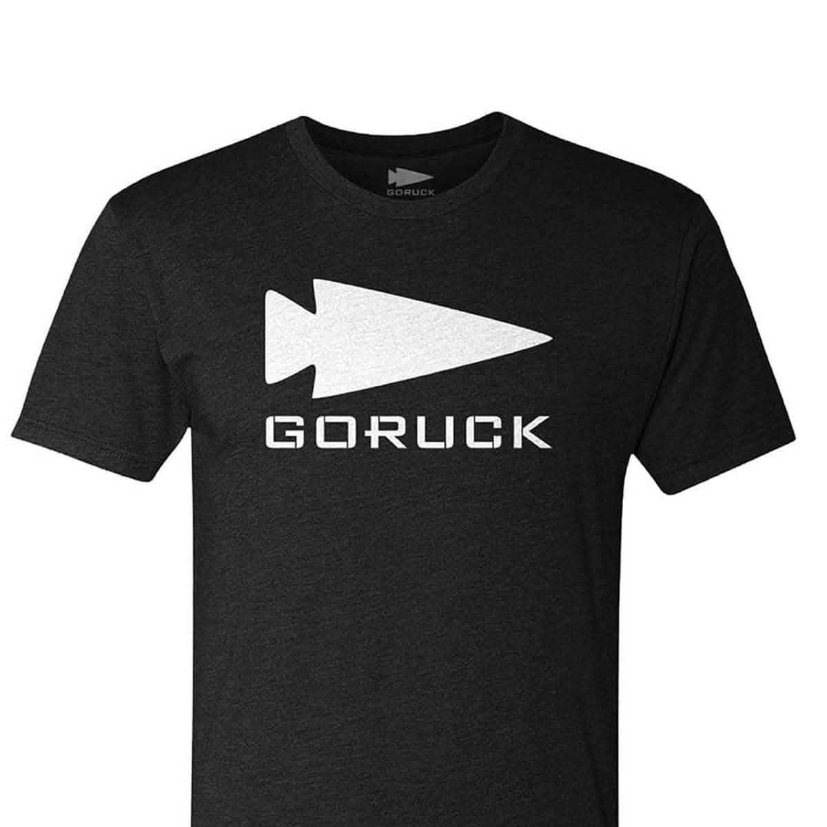 The GORUCK Spearhead Tee - Tri-BlendX is a black t-shirt with a white GORUCK spearhead symbol above bold, white 
