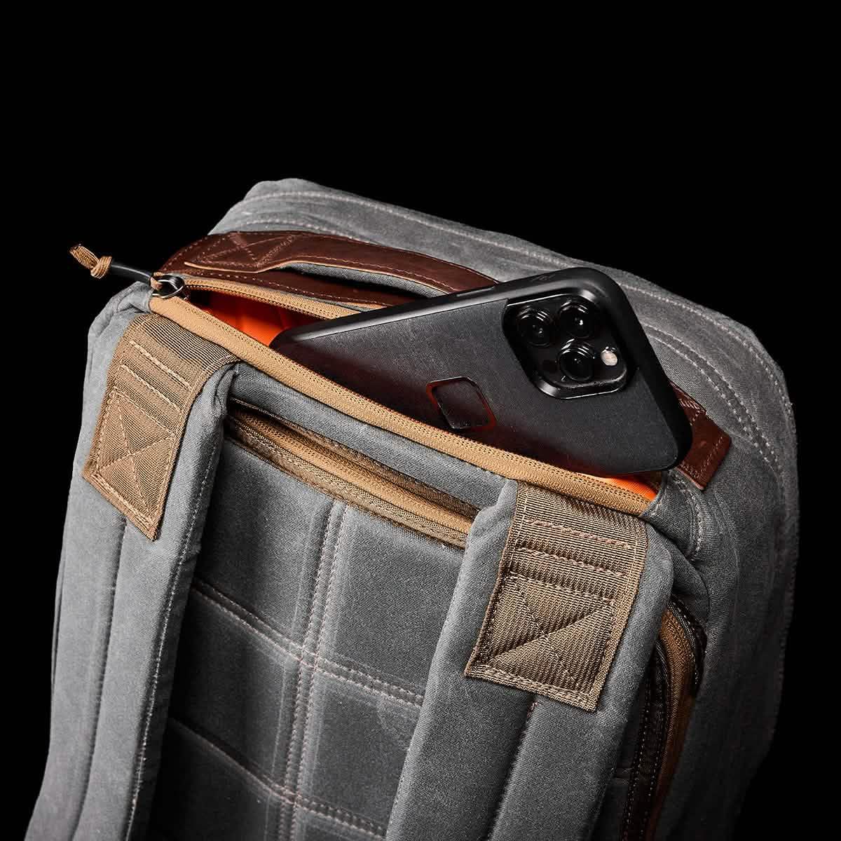 GORUCK Heritage Slate rucksack with phone in top zippered pocket, rugged gray fabric