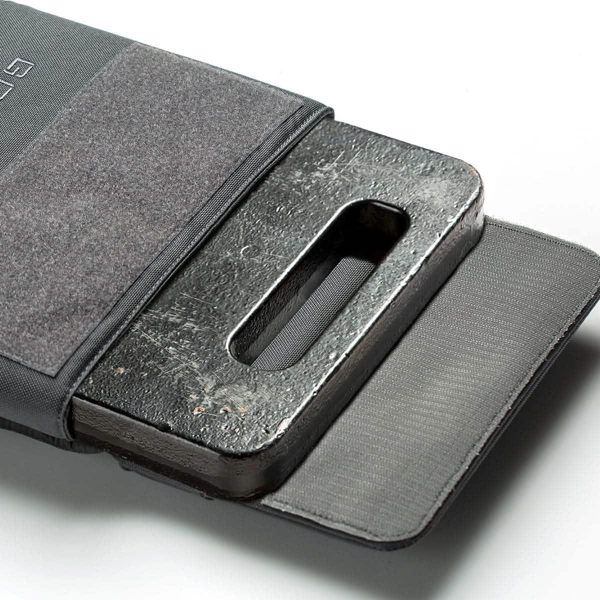 GORUCK ruck plate inserted in grey ruck plate carrier, tough workout gear on white background.