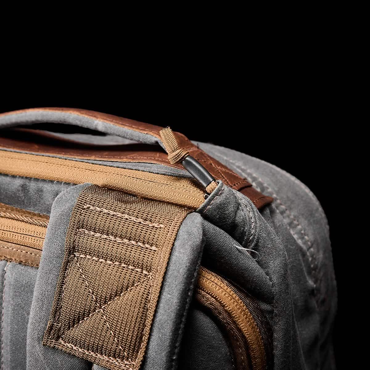 GORUCK heritage slate backpack corner showing rugged strap, zipper, and handle details