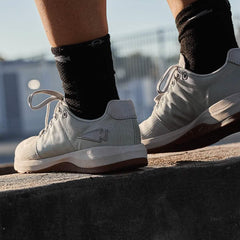GORUCK rucking shoe in lunar rock color worn outdoors on concrete step