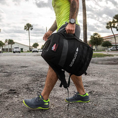 Man rucking outdoors with GORUCK backpack, athletic gear, and running shoes