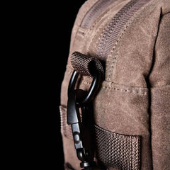 Close-up of GORUCK brown ruck sack with durable fabric and black carabiner clip