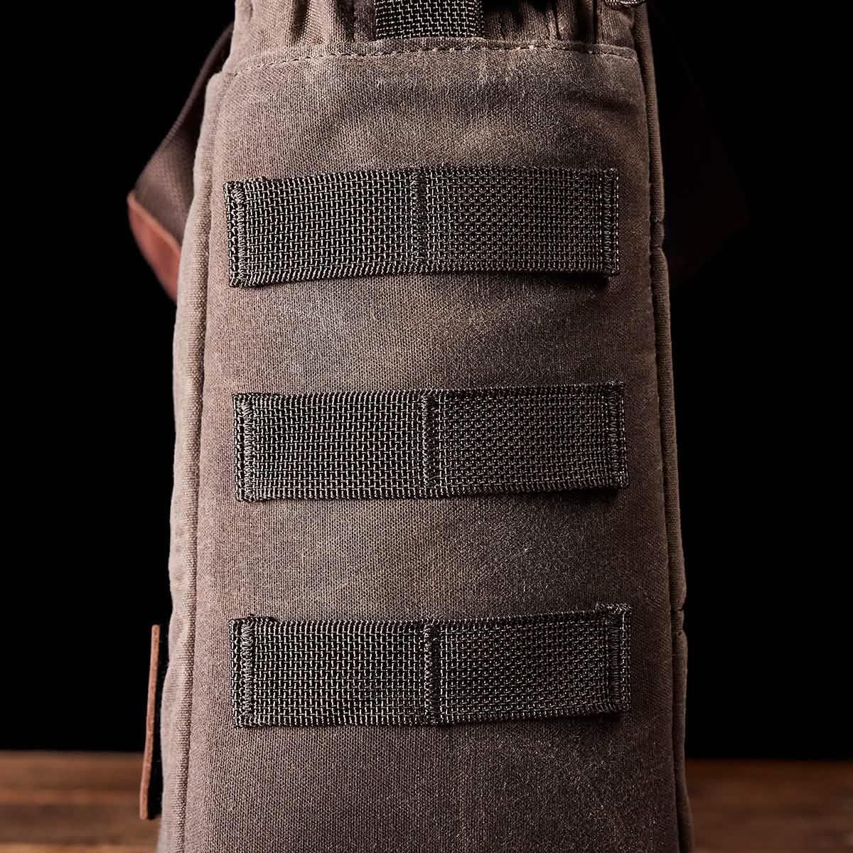 Close-up of GORUCK rugged brown backpack side MOLLE webbing for rucking gear attachment