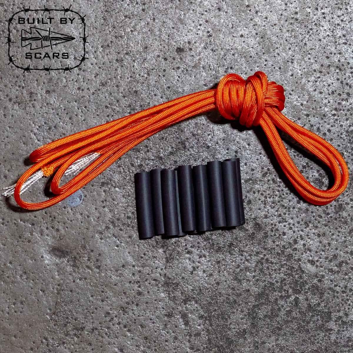 GORUCK orange paracord and black tubing on concrete, rucking gear accessories