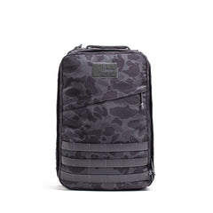 The GR1 is a black and gray camouflage everyday carry backpack featuring a front zipper pocket, horizontal strap details, and Special Forces grade durability.