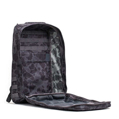 The GR1 rucksack, shown in black camo with the front flap open to reveal its mesh pocket and organizational panels, is built in the USA to Special Forces-grade standards.