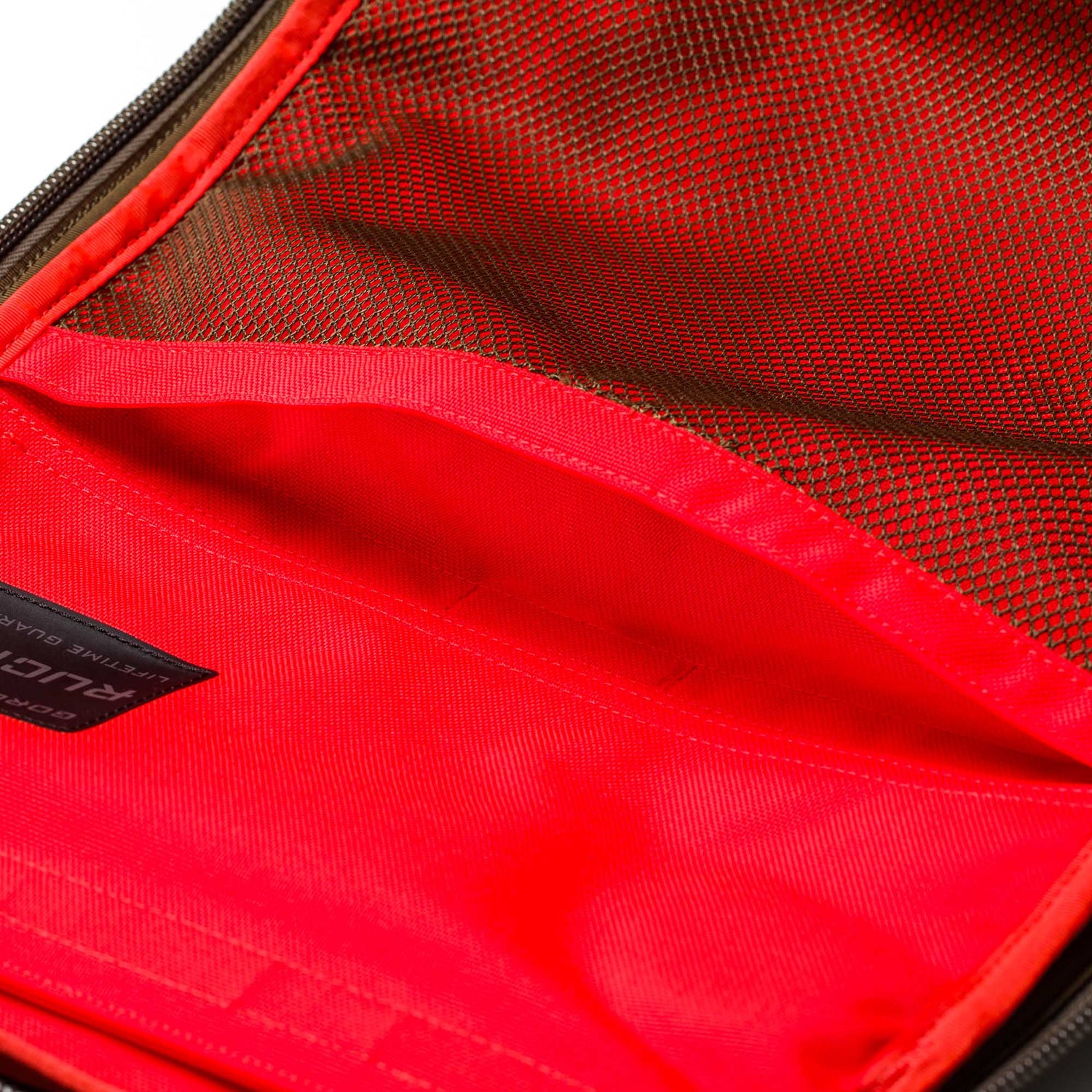 Close-up of an open Rucker 5.0 red fabric rucksack, highlighting its mesh pocket and visible stitching—perfect for rucking.