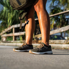 Woman rucking outdoors in GORUCK Ranger shoes with a backpack, sidewalk and palm trees