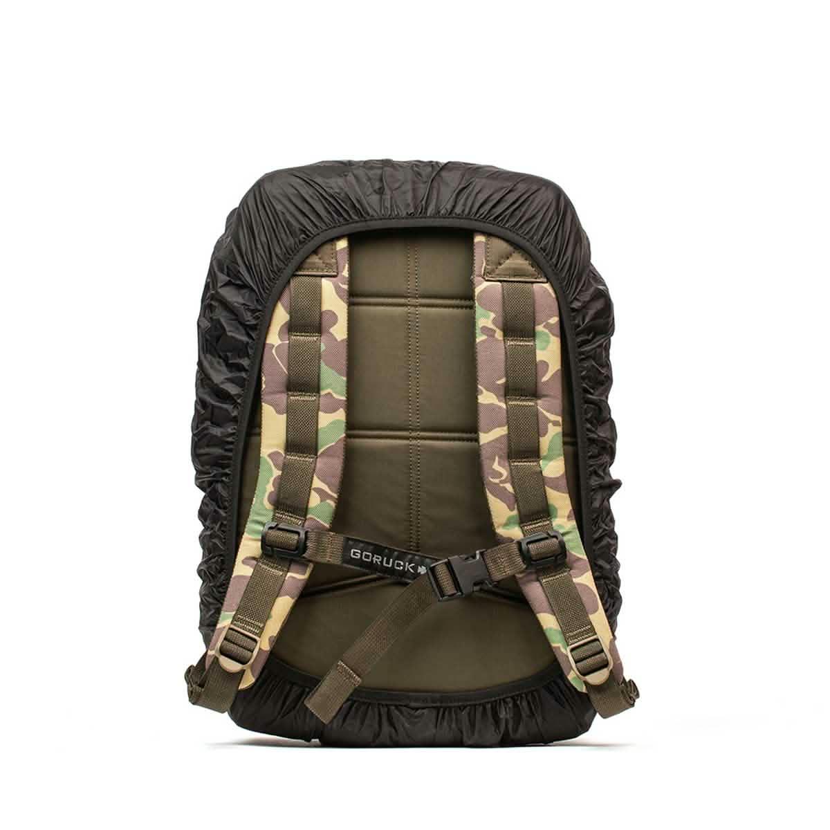 GORUCK camo rucksack with padded straps and black rain cover, rear view