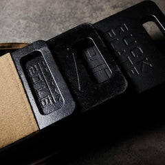 GORUCK ruck plates in a sand-colored rucksack, durable training gear on concrete surface