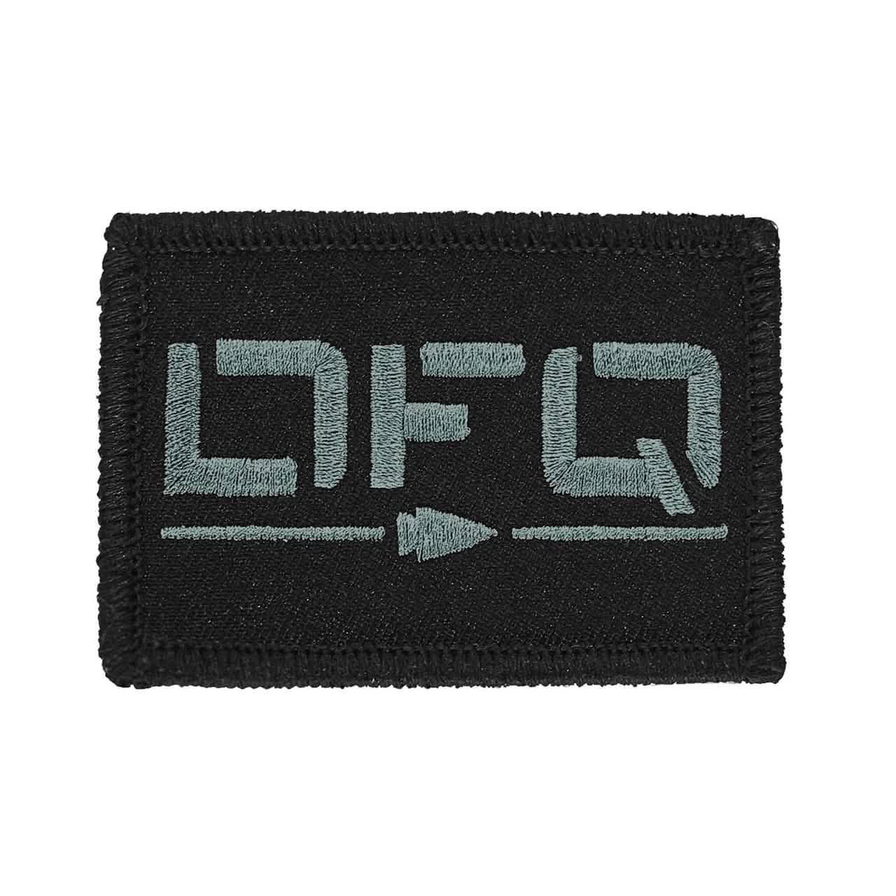 GORUCK black embroidered patch with stylized grey lettering and arrow design