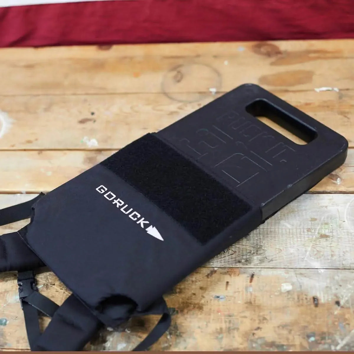 GORUCK 30lb ruck plate on wooden table with black cover, rucking gear equipment