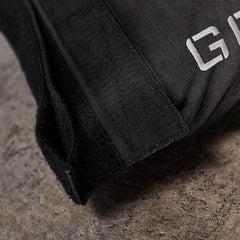 Close-up of GORUCK rucking gear with durable black fabric and Velcro on a concrete surface