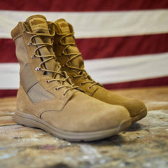 GORUCK coyote brown tactical boots on a rustic wooden surface with American flag background